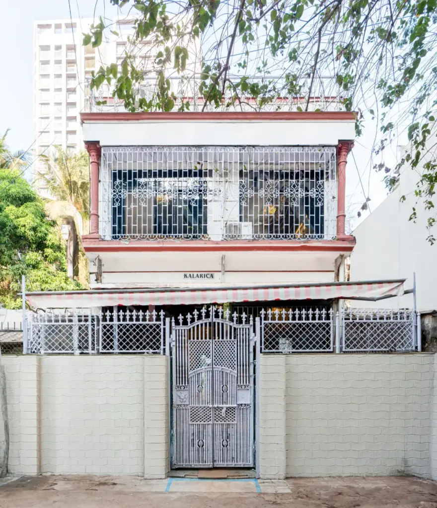 The sleek, modern architectural exterior of Garden Veil in Goregaon, cleverly masked by a natural curtain of tropical plants for ultimate privacy.