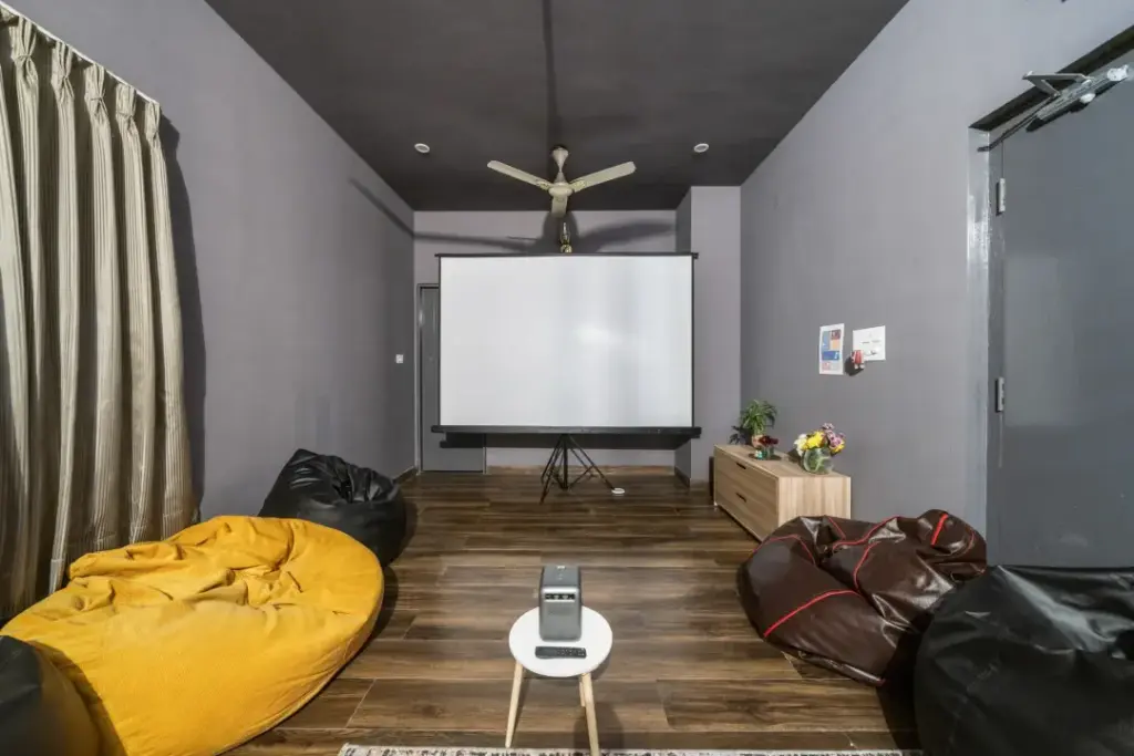 Professional executive workstation at Gatsby Grandeur featuring a high-definition projector and ergonomic desk for corporate presentations