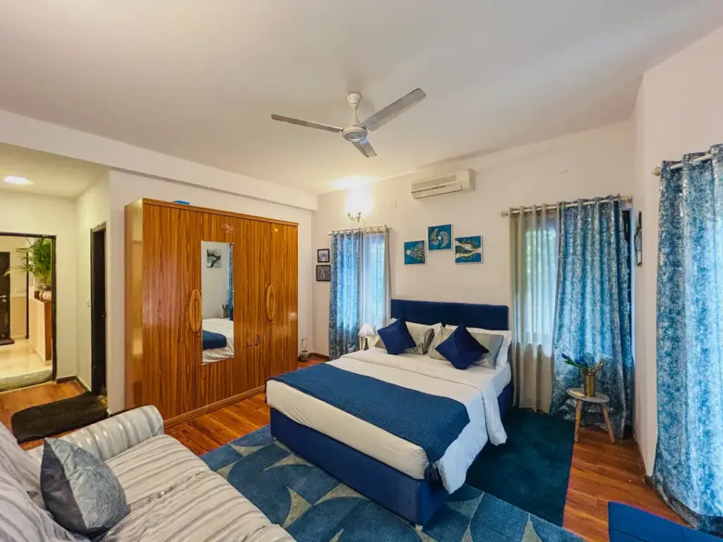 Elegantly designed master suite at Casa Blu Whitefield, featuring premium linens and mood lighting for a sophisticated Valentine’s Day stay.