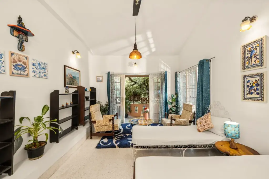 The vibrant, sun-filled living room at Heritage Haven, featuring high ceilings, eclectic decor, and cozy seating designed for long conversations.