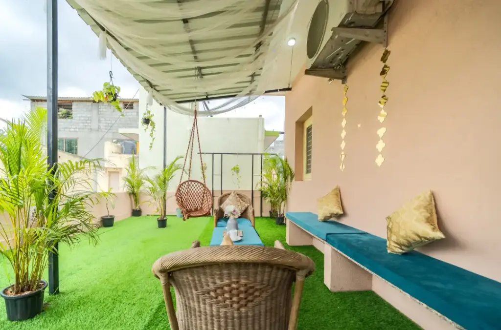 Spacious outdoor courtyard at Namma Morocco for guest relaxation featuring traditional mosaic tiles and open-air seating