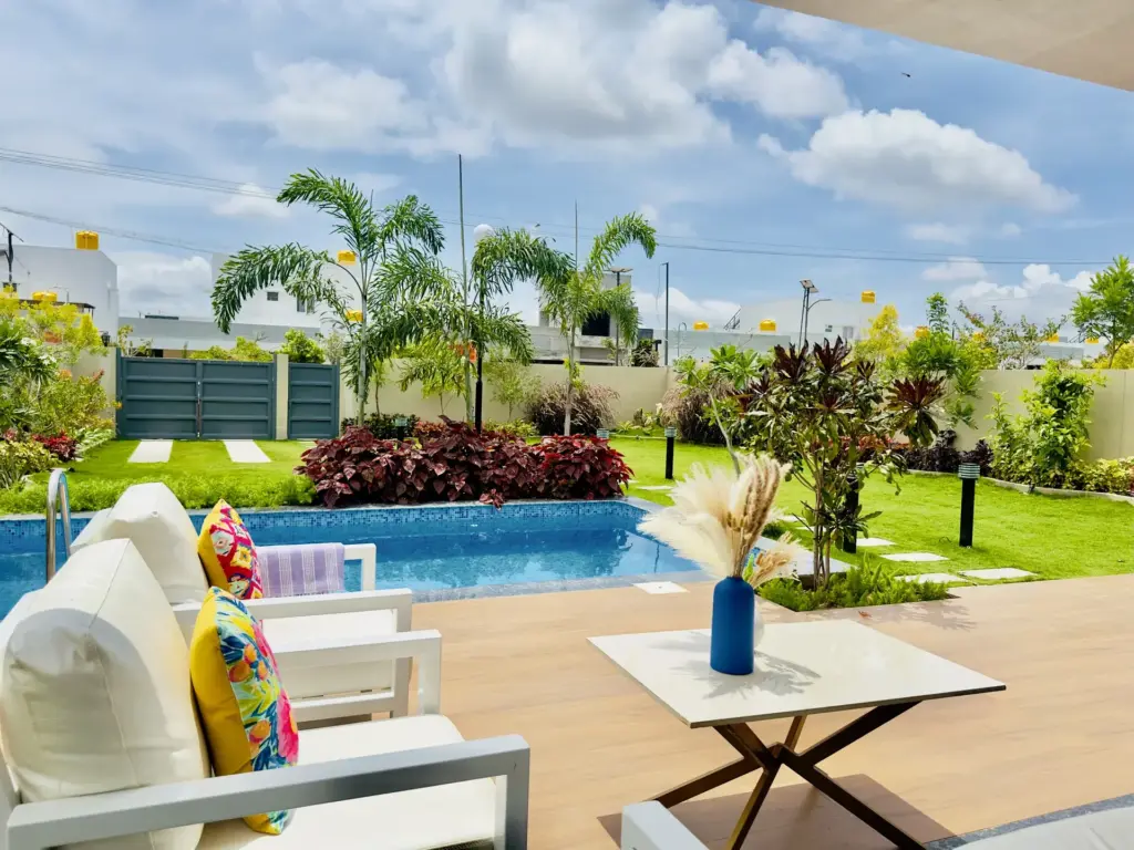 Artistic private swimming pool at Soul Club Spacez surrounded by boutique bohemian decor and lush garden greenery