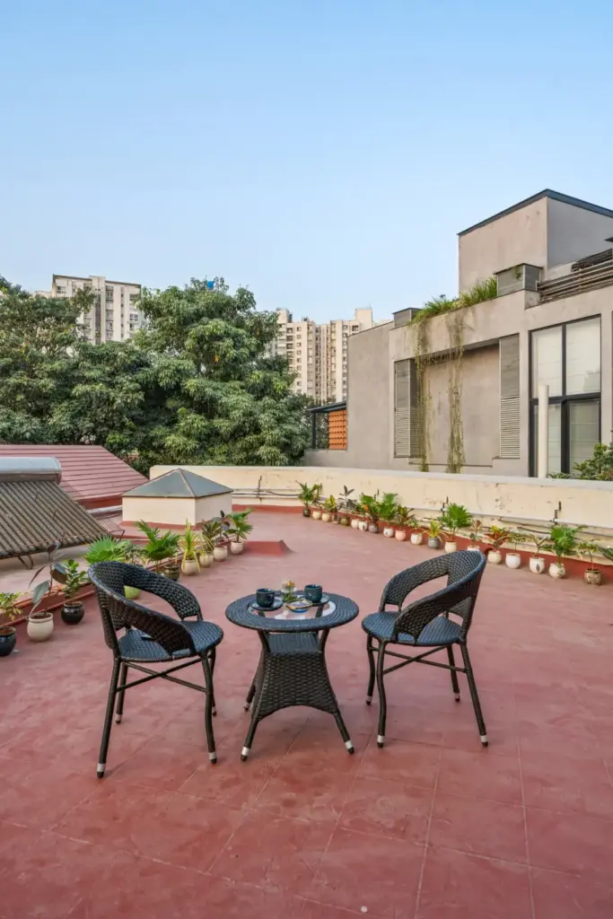 Wide open rooftop terrace at Natures Novelle offering panoramic views of the Sarjapur countryside for evening gatherings and outdoor yoga