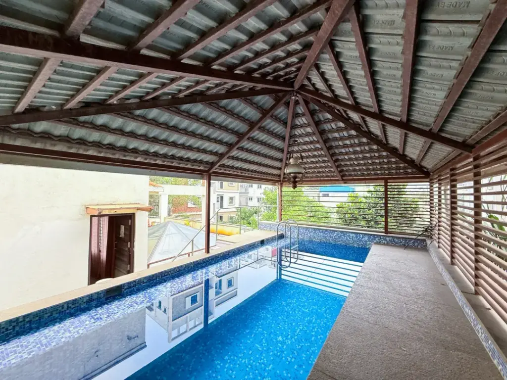 Private lagoon-style swimming pool at Spacez Lagoon Luxe Bengaluru with premium deck lighting for luxury evening pool parties