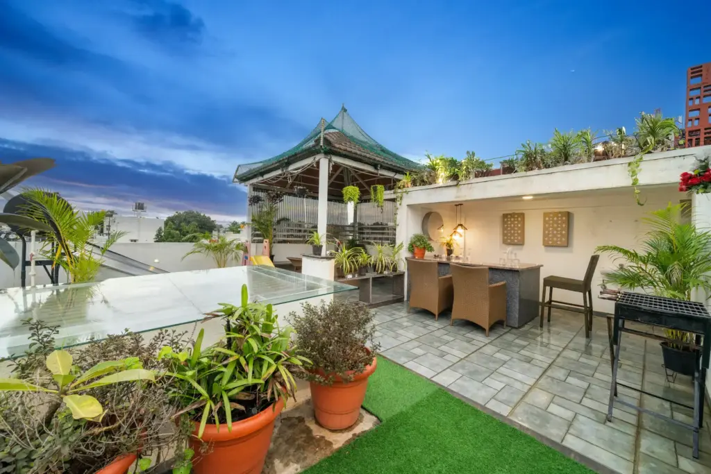 Twilight Terrace Spacez rooftop lounge with outdoor seating and Bengaluru city skyline view during sunset