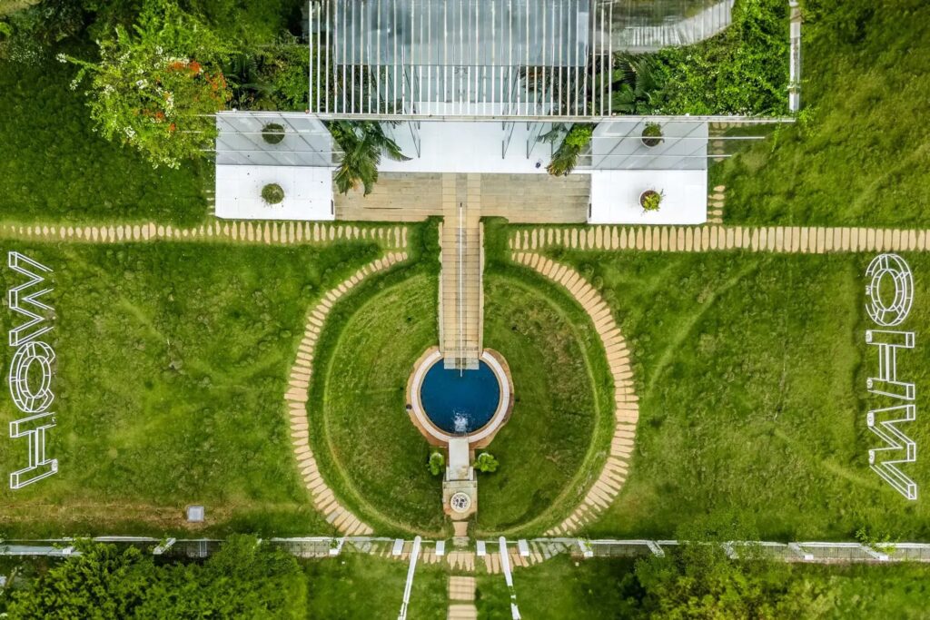 Here are the optimized alt texts for these specific images, balanced for SEO and accessibility:

Aerial Top View of Pool and Garden:

Alt Text: Aerial drone view of Crystal Hall in Rampura Bengaluru, showcasing the circular private swimming pool, 10,000 sq. ft. lush green lawn, and the unique all-glass architectural layout.