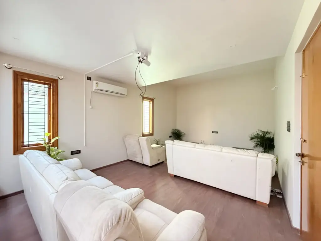 Professional-grade private home theater at Urban Utopia Bengaluru, featuring premium leather loungers, 4K projector setup, and high-fidelity sound for an exclusive IPL 2026 watch party.