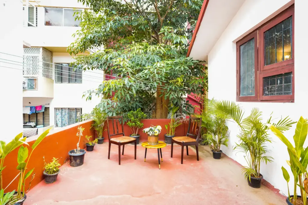 Spacious open-air balcony at Cine Castle offering a serene green view of Bengaluru’s canopy, perfect for a relaxed morning coffee or a private post-match celebration after an RCB win.