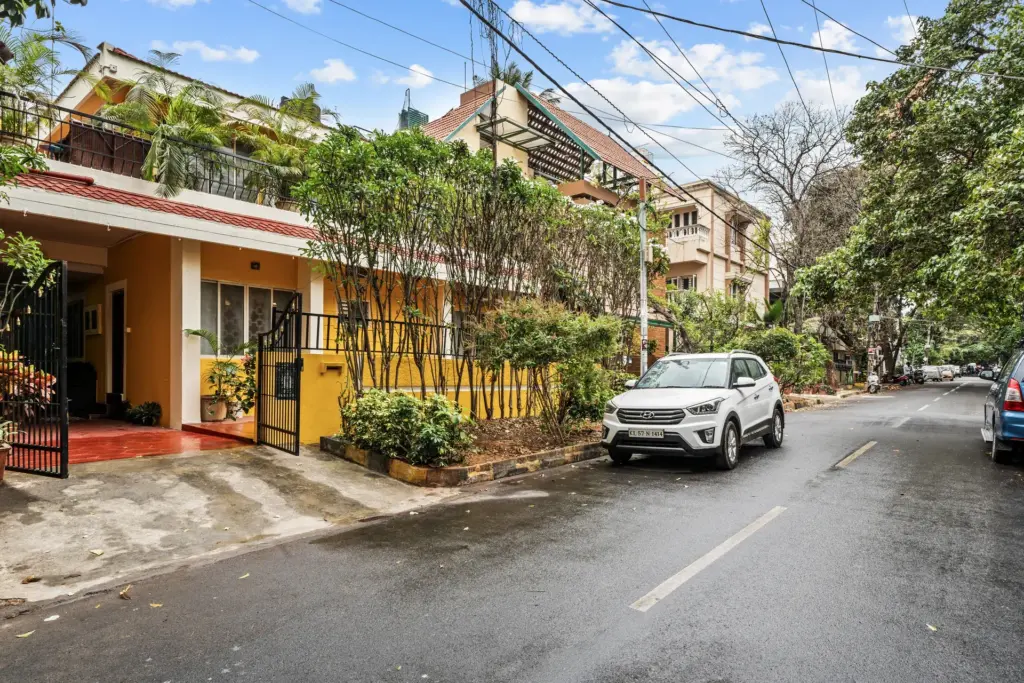 Grand entrance of Vintage Haven by Spacez, a 4BHK luxury villa in Indiranagar Bengaluru featuring classic wooden architecture and a private gated entry just 300m from the Metro.