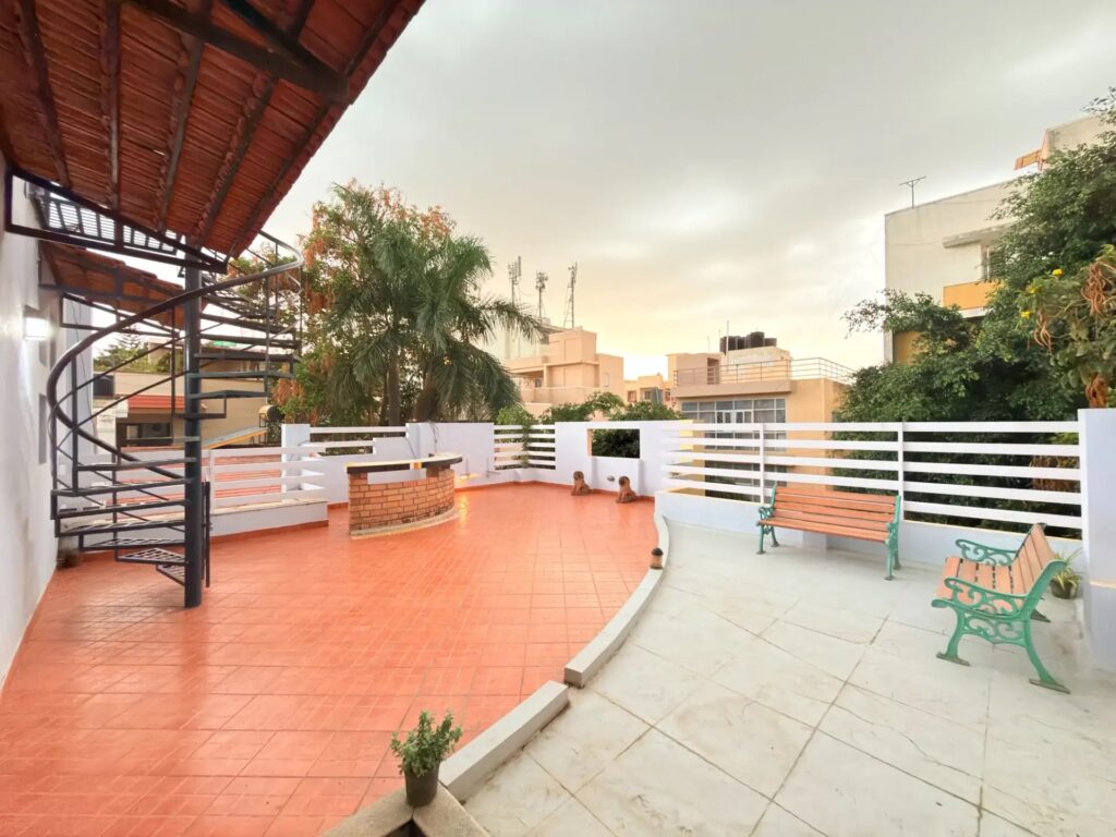 Open-air luxury rooftop terrace seating area at a private Spacez villa in Bangalore.