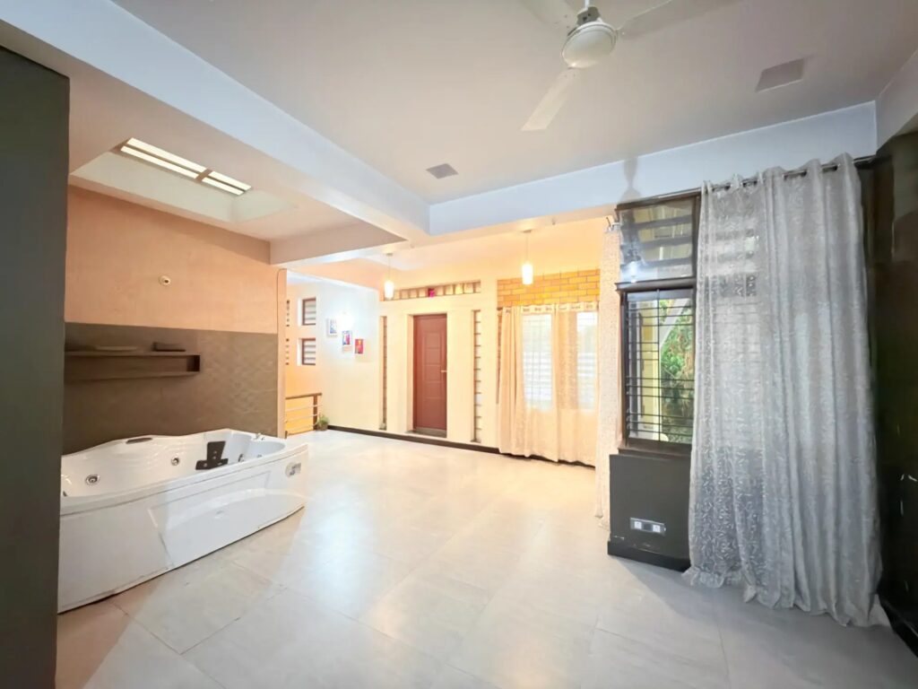 Luxury indoor wellness lounge with a giant private jacuzzi and modern ambient accent lighting.